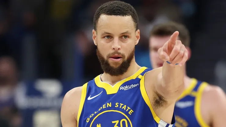 Stephen Curry #30 of the Golden State Warriors points to a teammate during a game.