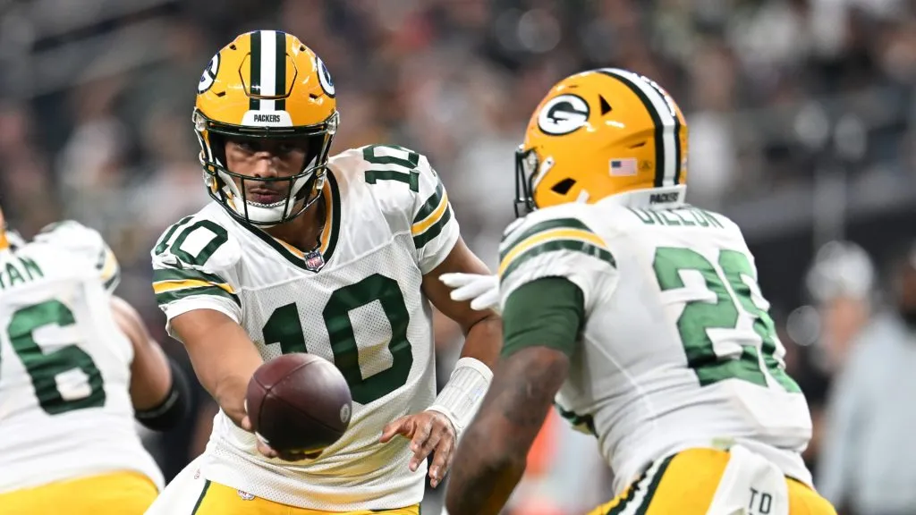 Jordan Love #10 of the Green Bay Packers hands the ball to AJ Dillon #28 during the first quarter against the Las Vegas Raiders at Allegiant Stadium on October 09, 2023 in Las Vegas, Nevada.