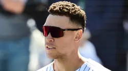 Giancarlo Stanton #27 and Aaron Judge #99 of the New York Yankees stand for the national anthem prior to a Grapefruit League spring training game against the Tampa Bay Rays at George M. Steinbrenner Field on February 21, 2025 in Tampa, Florida.