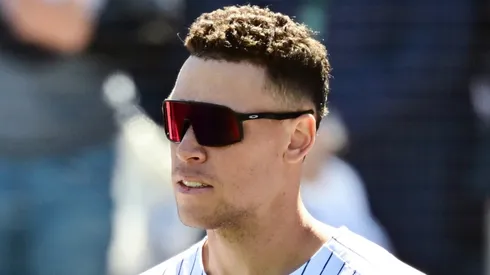 Giancarlo Stanton #27 and Aaron Judge #99 of the New York Yankees stand for the national anthem prior to a Grapefruit League spring training game against the Tampa Bay Rays at George M. Steinbrenner Field on February 21, 2025 in Tampa, Florida.