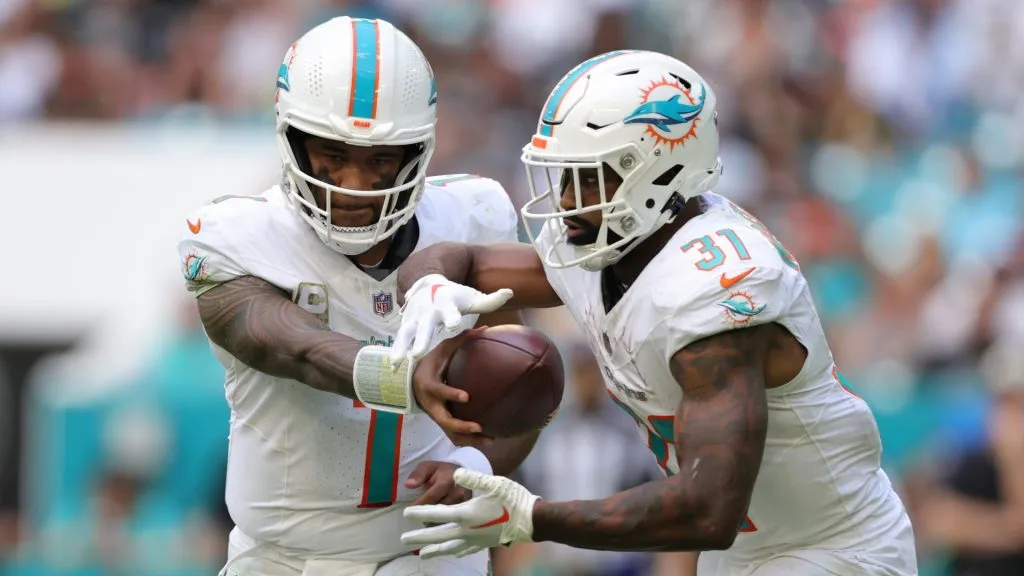 Tua Tagovailoa #1 of the Miami Dolphins hands the ball off to teammate Raheem Mostert #31 during the third quarter against the Las Vegas Raiders at Hard Rock Stadium on November 19, 2023 in Miami Gardens, Florida.