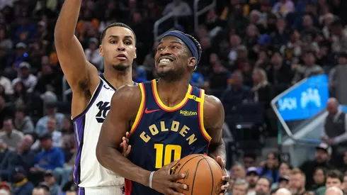Jimmy Butler III #10 of the Golden State Warriors drives to the basket on Keegan Murray #13 of the Sacramento Kings