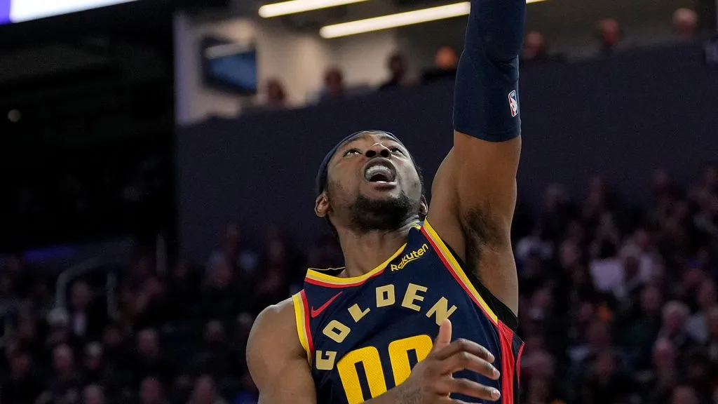 Jonathan Kuminga #00 of the Golden State Warriors shoots and gets fouled by DeMar DeRozan #10 of the Sacramento Kings