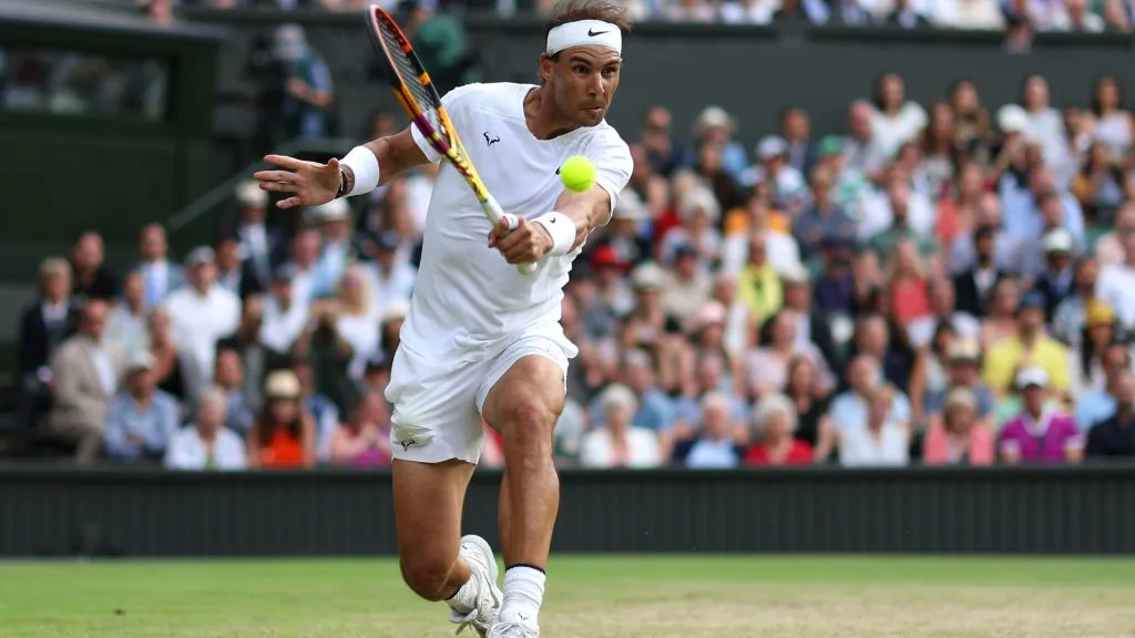 Rafael Nadal of Spain plays a backhand against Taylor Fritz of The United States during Wimbledon 2022. (Clive Brunskill/Getty Images)