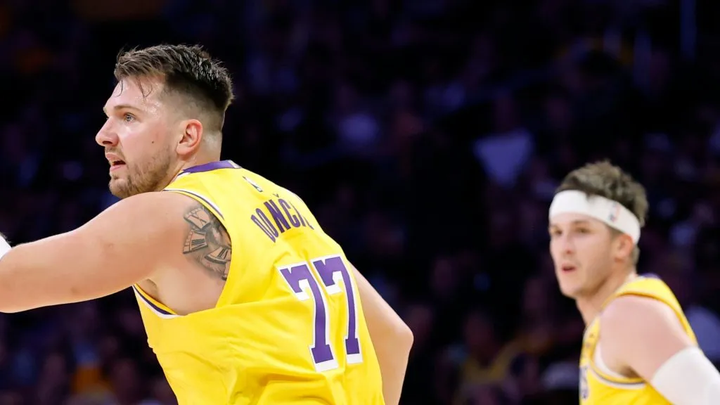 Luka Doncic #77 of the Los Angeles Lakers reacts to basket with Austin Reaves #15 during the first half against the Minnesota Timberwolves 