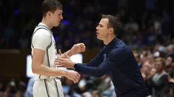 Head coach Jon Scheyer of the Duke Blue Devils speaks with Cooper Flagg #2 during the second half of the game against the North Carolina Tar Heels at Cameron Indoor Stadium on February 01, 2025 in Durham, North Carolina.