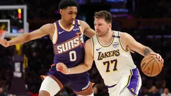 Luka Doncic #77 of the Los Angeles Lakers handles the ball defended by Ryan Dunn #0 of the Phoenix Suns in the first half at Crypto.com Arena on March 16, 2025 in Los Angeles, California.