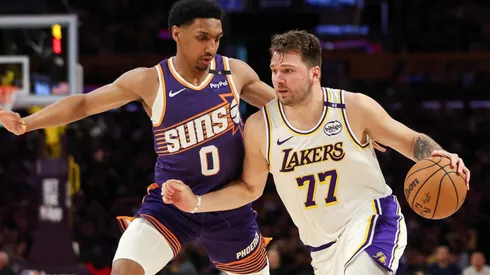 Luka Doncic #77 of the Los Angeles Lakers handles the ball defended by Ryan Dunn #0 of the Phoenix Suns in the first half at Crypto.com Arena on March 16, 2025 in Los Angeles, California.
