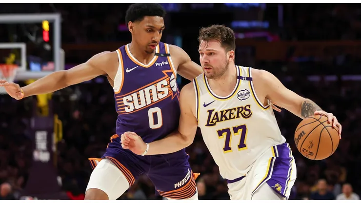 Luka Doncic #77 of the Los Angeles Lakers handles the ball defended by Ryan Dunn #0 of the Phoenix Suns in the first half at Crypto.com Arena on March 16, 2025 in Los Angeles, California.