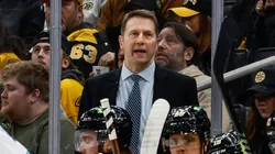 Boston Bruins interim head coach Joe Sacco talks to his players behind the bench during the first period against the Utah Hockey Club at TD Garden on November 21, 2024 in Boston, Massachusetts.