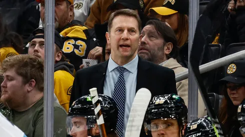 Boston Bruins interim head coach Joe Sacco talks to his players behind the bench during the first period against the Utah Hockey Club at TD Garden on November 21, 2024 in Boston, Massachusetts.