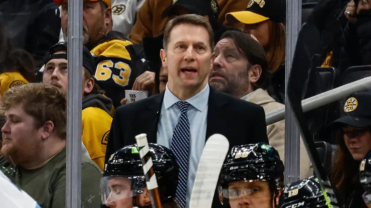 Boston Bruins interim head coach Joe Sacco talks to his players behind the bench during the first period against the Utah Hockey Club at TD Garden on November 21, 2024 in Boston, Massachusetts.