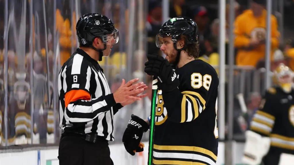 David Pastrnak #88 of the Boston Bruins speaks to referee Francois St. Laurent #8 during the third period against the Florida Panthers in Game Three of the Second Round of the 2024 Stanley Cup Playoffs at TD Garden on May 10, 2024 in Boston, Massachusetts.