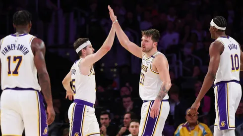 Luka Doncic #77 of the Los Angeles Lakers high-fives Austin Reaves #15 in the second half against the Phoenix Suns at Crypto.com Arena on March 16, 2025 in Los Angeles, California.