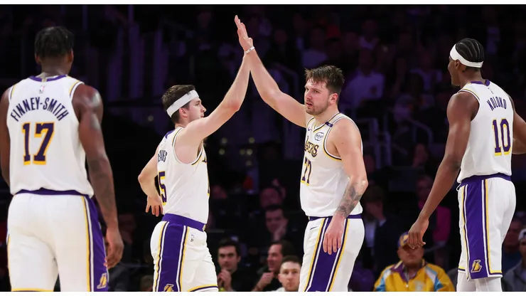 Luka Doncic #77 of the Los Angeles Lakers high-fives Austin Reaves #15 in the second half against the Phoenix Suns at Crypto.com Arena on March 16, 2025 in Los Angeles, California.