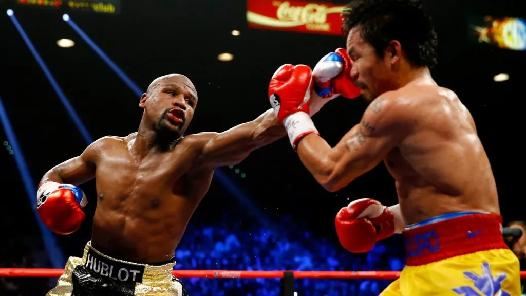 Floyd Mayweather Jr. throws a left at Manny Pacquiao during their welterweight unification championship bout on May 2, 2015. (Source: Al Bello/Getty Images)