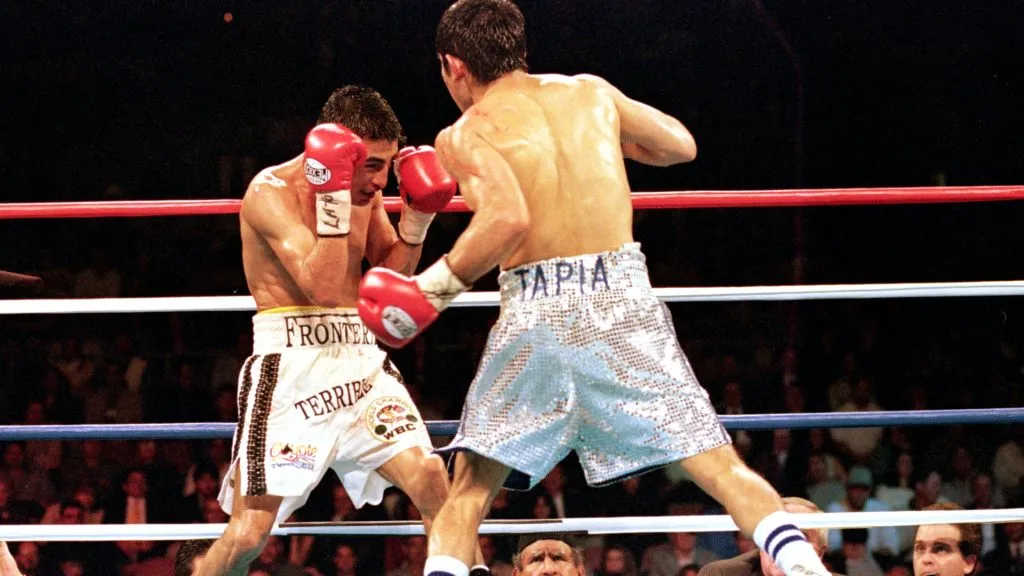 Marco Barrera swings to land a left punch during the WBC/WBO Super Bantamwight Championship against Erik Morales in Las Vegas in 2000. (Source: Jed Jacobsohn /Allsport)