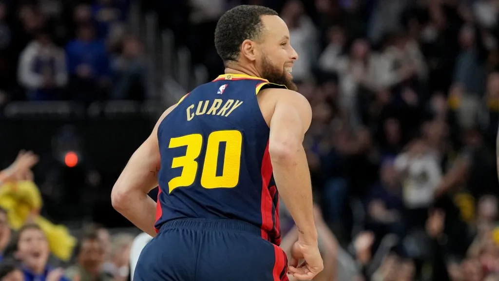 Stephen Curry #30 of the Golden State Warriors runs back down court smiling after making his 4000th career three-pointer against the Sacramento Kings. (Thearon W. Henderson/Getty Images)