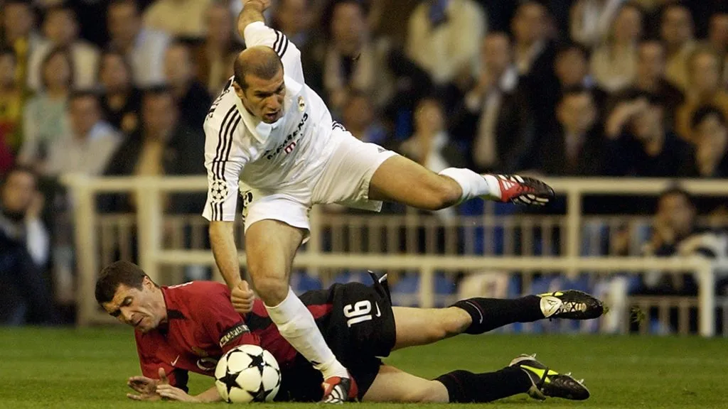 Zinedine Zidane uses his skill to take the ball past Roy Keane during a UEFA Champions League match between Real Madrid and Manchester United. (Shaun Botterill/Getty Images)