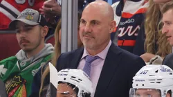 Head coach Rick Tocchet of the Vancouver Canucks talks with assistant coach Yogi Svejkovsky against the Chicago Blackhawks during the first period at the United Center on October 22, 2024 in Chicago, Illinois.