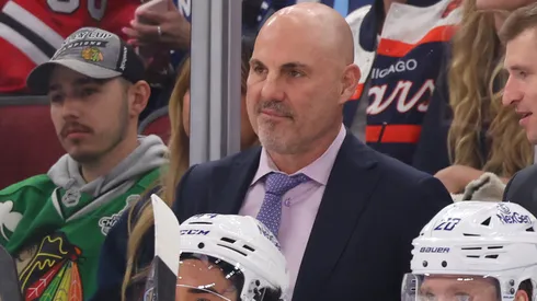 Head coach Rick Tocchet of the Vancouver Canucks talks with assistant coach Yogi Svejkovsky against the Chicago Blackhawks during the first period at the United Center on October 22, 2024 in Chicago, Illinois.