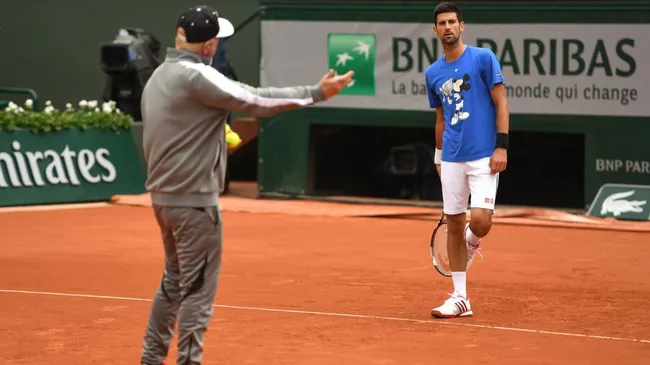 Novak Djokovic of Serbia speaks with coach Boris Becker during a training session on day fourteen of the 2016 French Open at Roland Garros. (Dennis Grombkowski/Getty Images)