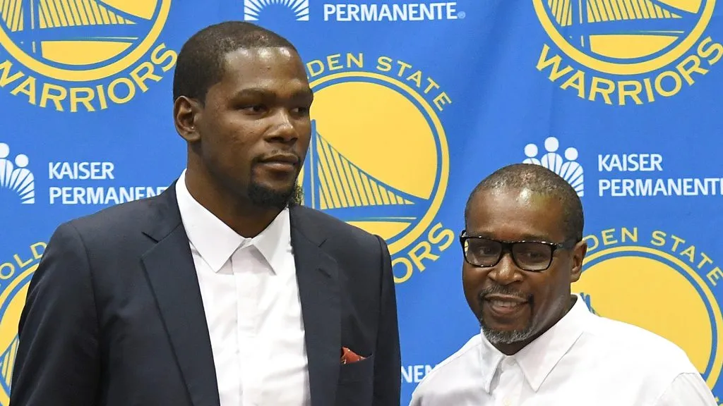 Kevin Durant #35 of the Golden State Warriors stands with his father Wayne Pratt and poses with his new jersey during the press conference where Durant was introduced as a member of the Golden State Warriors 