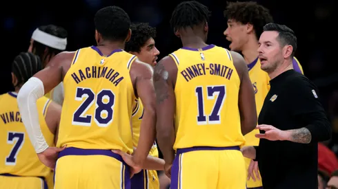 Head coach JJ Redick of the Los Angeles Lakers speaks with Dorian Finney-Smith #17 and Rui Hachimura #28 after a timeout during a 117-96 Lakers win over the Boston Celtics.