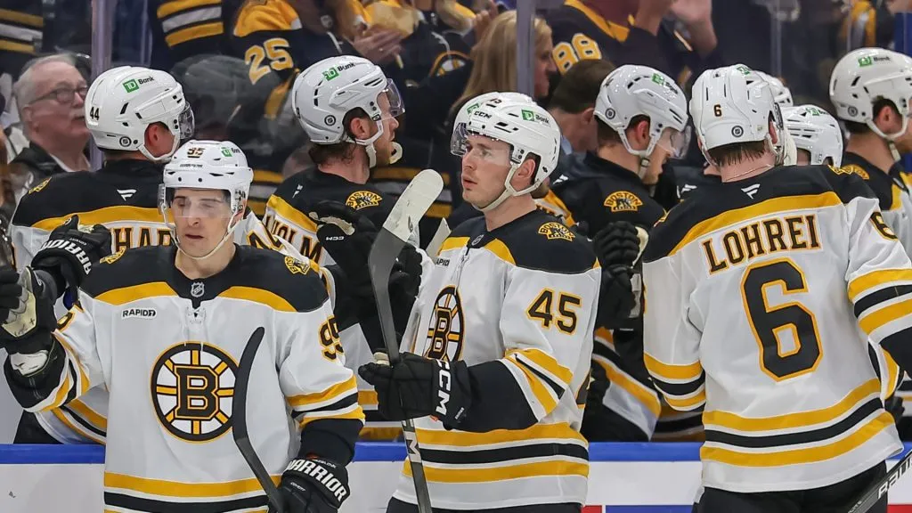 Boston Bruins skate by and celebrate with their teammates after a goal by Koepke against the Tampa Bay Lightning during the second period at the Amalie Arena on March 8, 2025 in Tampa, Florida.