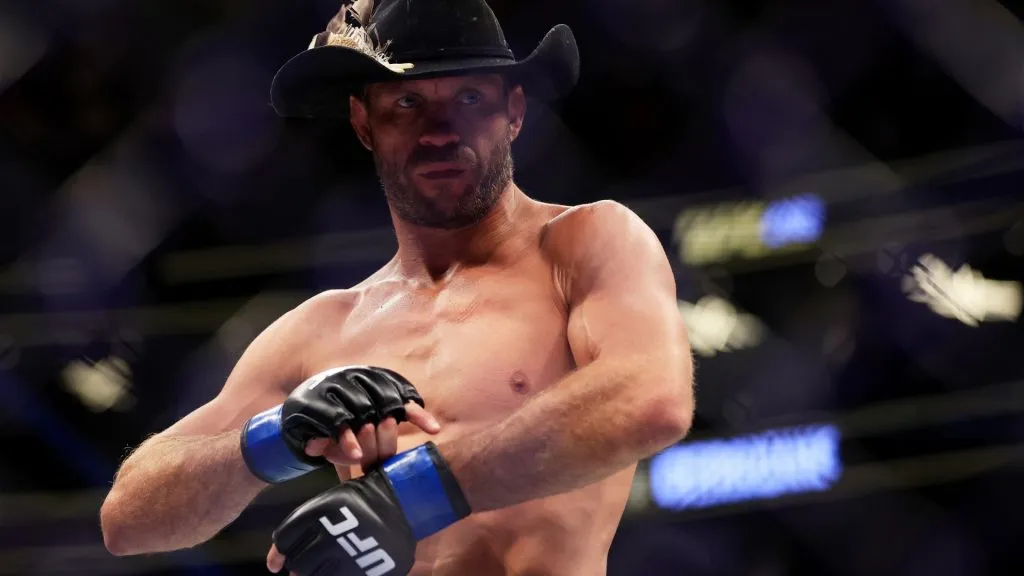 Donald Cerrone takes off his gloves as he announces his retirement after his welterweight bout against Jim Miller during UFC 276 at T-Mobile Arena on July 02, 2022. (Source: Carmen Mandato/Getty Images)