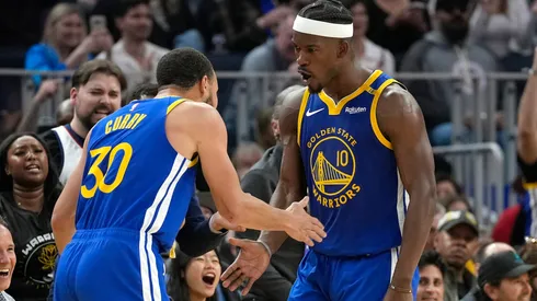 Jimmy Butler III #10 and Stephen Curry #30 of the Golden State Warriors celebrate after Butler scored and was fouled on the shot against the Dallas Mavericks during the first half at Chase Center on February 23, 2025 in San Francisco, California.
