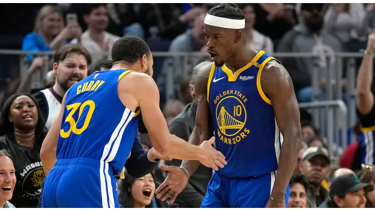 Jimmy Butler III #10 and Stephen Curry #30 of the Golden State Warriors celebrate after Butler scored and was fouled on the shot against the Dallas Mavericks during the first half at Chase Center on February 23, 2025 in San Francisco, California.