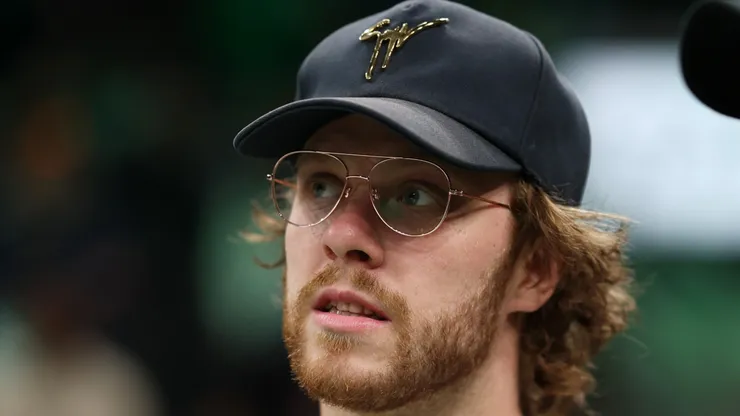 Boston Bruins players David Pastrnak and Charlie McAvoy attend Game One of the Eastern Conference First Round Playoffs between the Boston Celtics and the Atlanta Hawks at TD Garden on April 15, 2023 in Boston, Massachusetts.