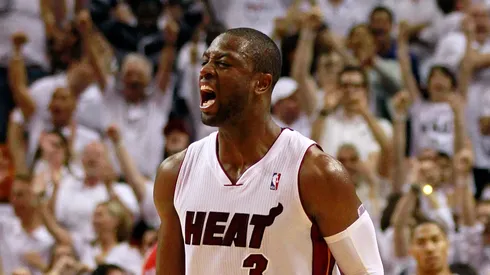 Dwyane Wade #3 of the Miami Heat celebrates as Derrick Rose #1 of the Chicago Bulls looks on dejected in Game Four of the Eastern Conference Finals