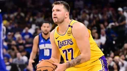 Luka Doncic #77 of the Los Angeles Lakers steps back to take a shot beyond the three-point-line against Caleb Houstan #2 of the Orlando Magic in the first half of a game at Kia Center on March 24, 2025 in Orlando, Florida.