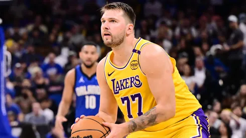 Luka Doncic #77 of the Los Angeles Lakers steps back to take a shot beyond the three-point-line against Caleb Houstan #2 of the Orlando Magic in the first half of a game at Kia Center on March 24, 2025 in Orlando, Florida.