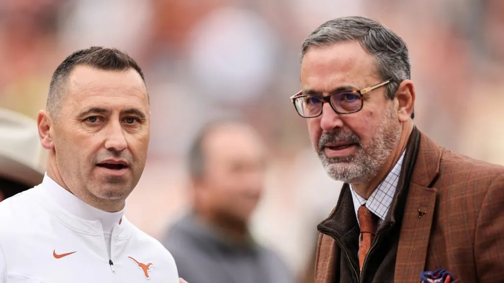 Head coach Steve Sarkisian of the Texas Longhorns talks with athletic director Chris Del Conte after the game against the Kansas State Wildcats at Darrell K Royal-Texas Memorial Stadium on November 26, 2021 in Austin, Texas.