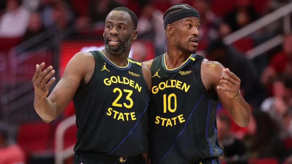 Draymond Green #23 and Jimmy Butler #10 of the Golden State Warriors speak on the court against the Houston Rockets during the first half at Toyota Center. (Alex Slitz/Getty Images)