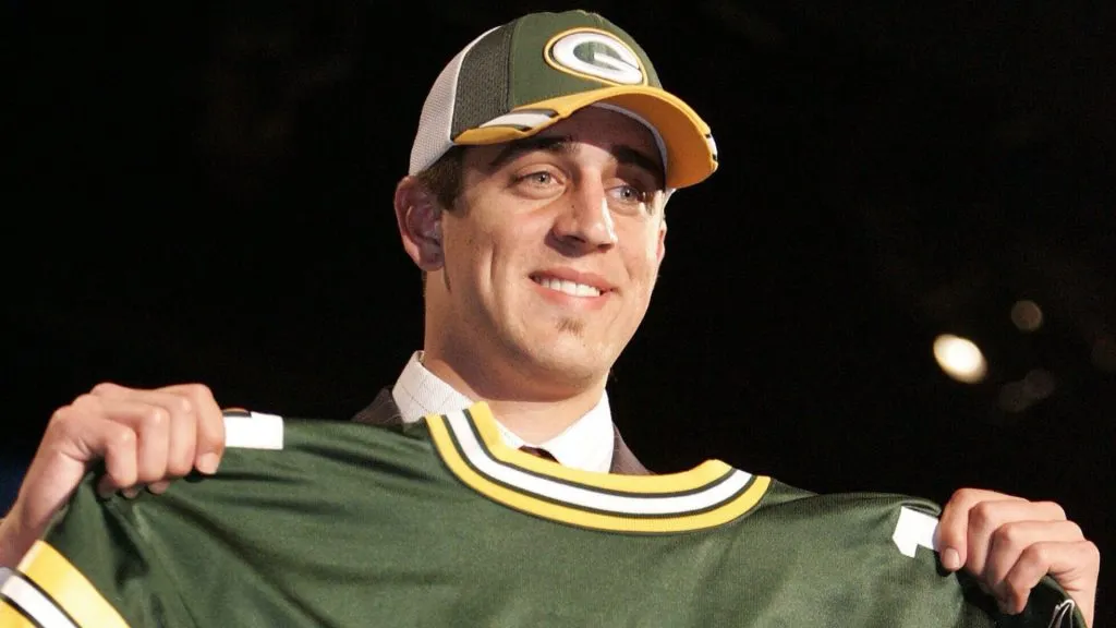 Aaron Rodgers at his official unveiling with the Packers, holding his #1 jersey. (Source: @packers)