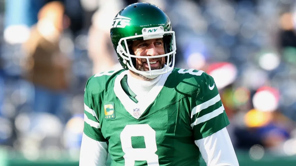 Aaron Rodgers #8 of the New York Jets smiles before a game against the Los Angeles Rams at MetLife Stadium on December 22, 2024. (Source: Emilee Chinn/Getty Images)