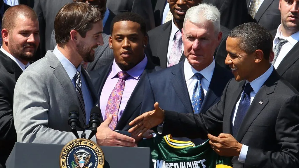 Barack Obama recieves a jersey from quarterback Aaron Rodgers  of the Green Bay Packers during a reception for the National Football League Super Bowl XLV champions in 2010. (Source: Mark Wilson/Getty Images)