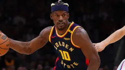 Jimmy Butler III #10 of the Golden State Warriors dribbles the ball against Tyler Herro #14 of the Miami Heat during the first quarter at Kaseya Center on March 25, 2025 in Miami, Florida.