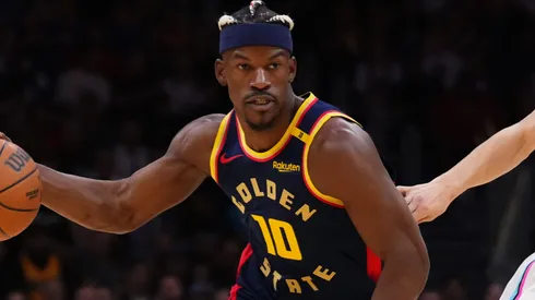 Jimmy Butler III #10 of the Golden State Warriors dribbles the ball against Tyler Herro #14 of the Miami Heat during the first quarter at Kaseya Center on March 25, 2025 in Miami, Florida.