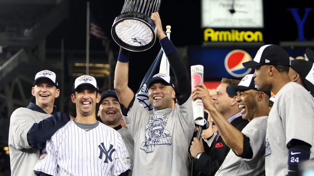 Derek Jeter #2 of the New York Yankees holds up the trophy as he celebrates with his teammates in 2009. (Source: Jed Jacobsohn/Getty Images)