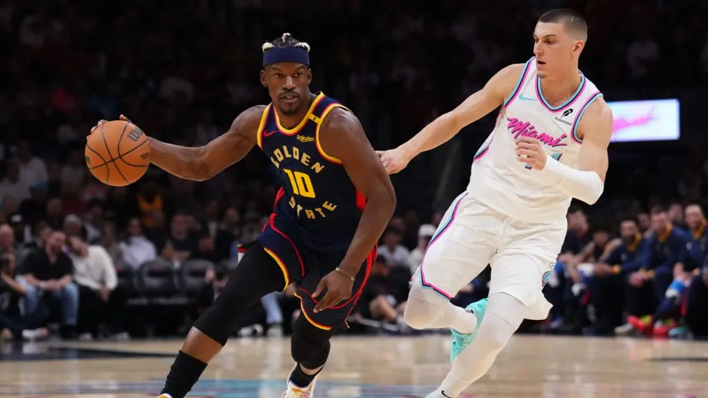 Jimmy Butler III #10 of the Golden State Warriors dribbles the ball against Tyler Herro #14 of the Miami Heat during the first quarter at Kaseya Center. (Rich Storry/Getty Images)