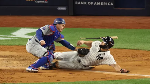 Will Smith #16 of the Los Angeles Dodgers tags out Giancarlo Stanton #27 of the New York Yankees in the fourth inning during Game Three of the 2024 World Series.