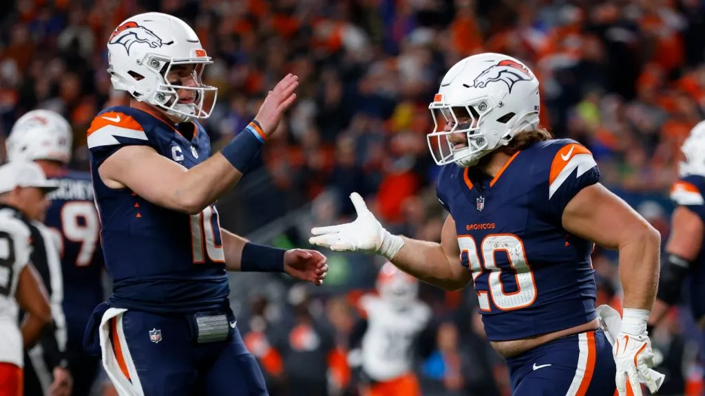 Michael Burton #20 and Bo Nix #10 of the Denver Broncos celebrate a touchdown during the second quarter in the game against the Cleveland Browns at Empower Field At Mile High on December 02, 2024 in Denver, Colorado.