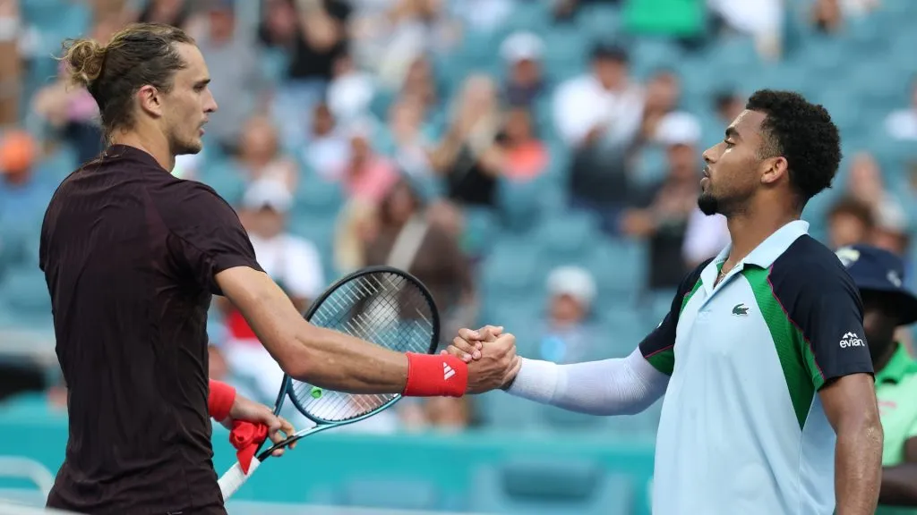 Arthur Fils of France meets Alexander Zverev of Germany at the net after defeating him on Day 9 of the Miami Open