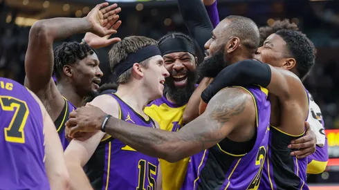 The Los Angeles Lakers celebrate with LeBron James #23 after a buzzer-beating tip-in to defeat the Indiana Pacers at Gainbridge Fieldhouse.