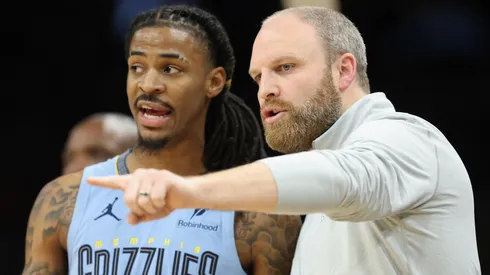 Head coach Taylor Jenkins (R) of the Memphis Grizzlies talks with Ja Morant #12 during the second half of the NBA game at Footprint Center on February 11, 2025 in Phoenix, Arizona.